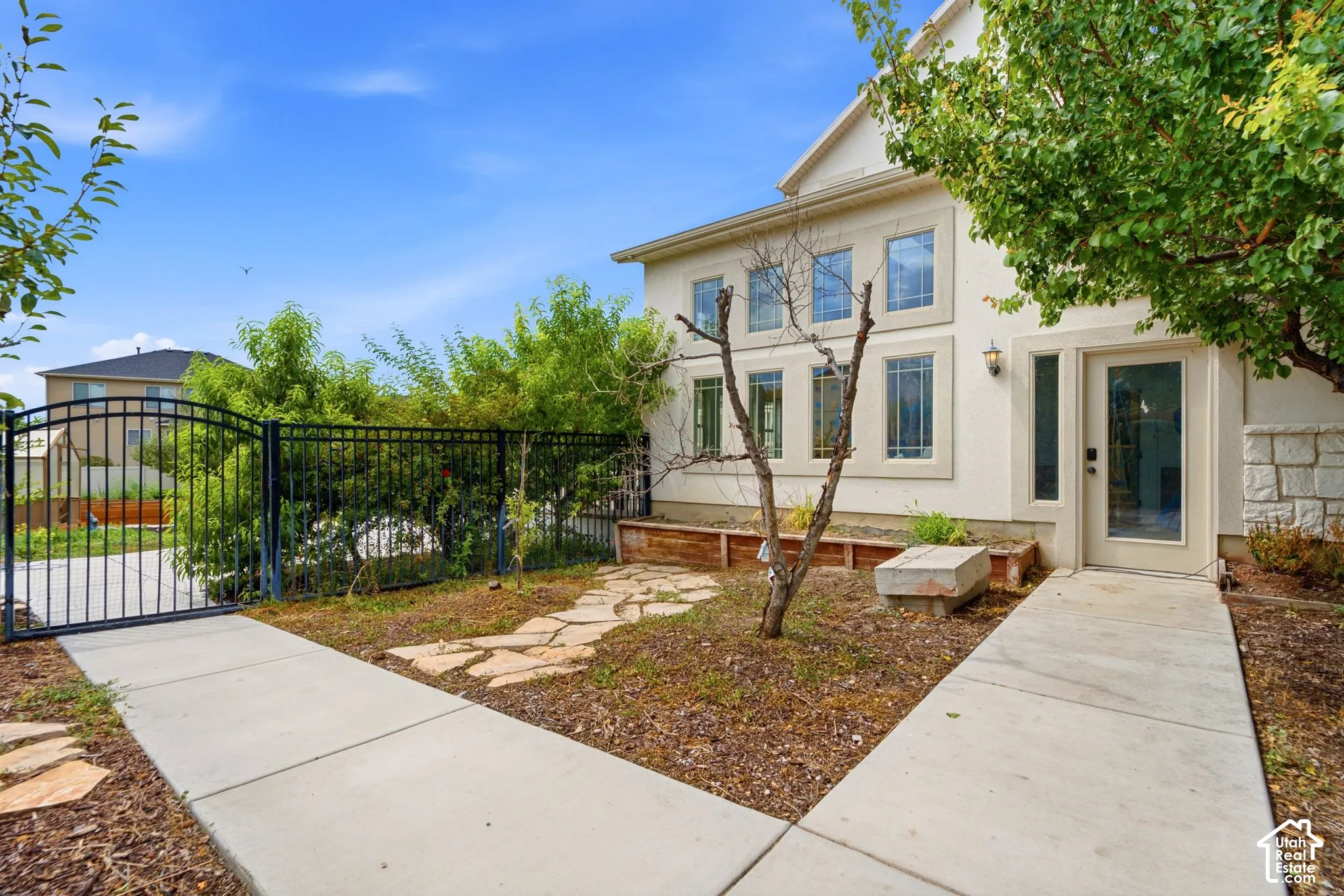 Cream stucco exterior with stacked stone accents