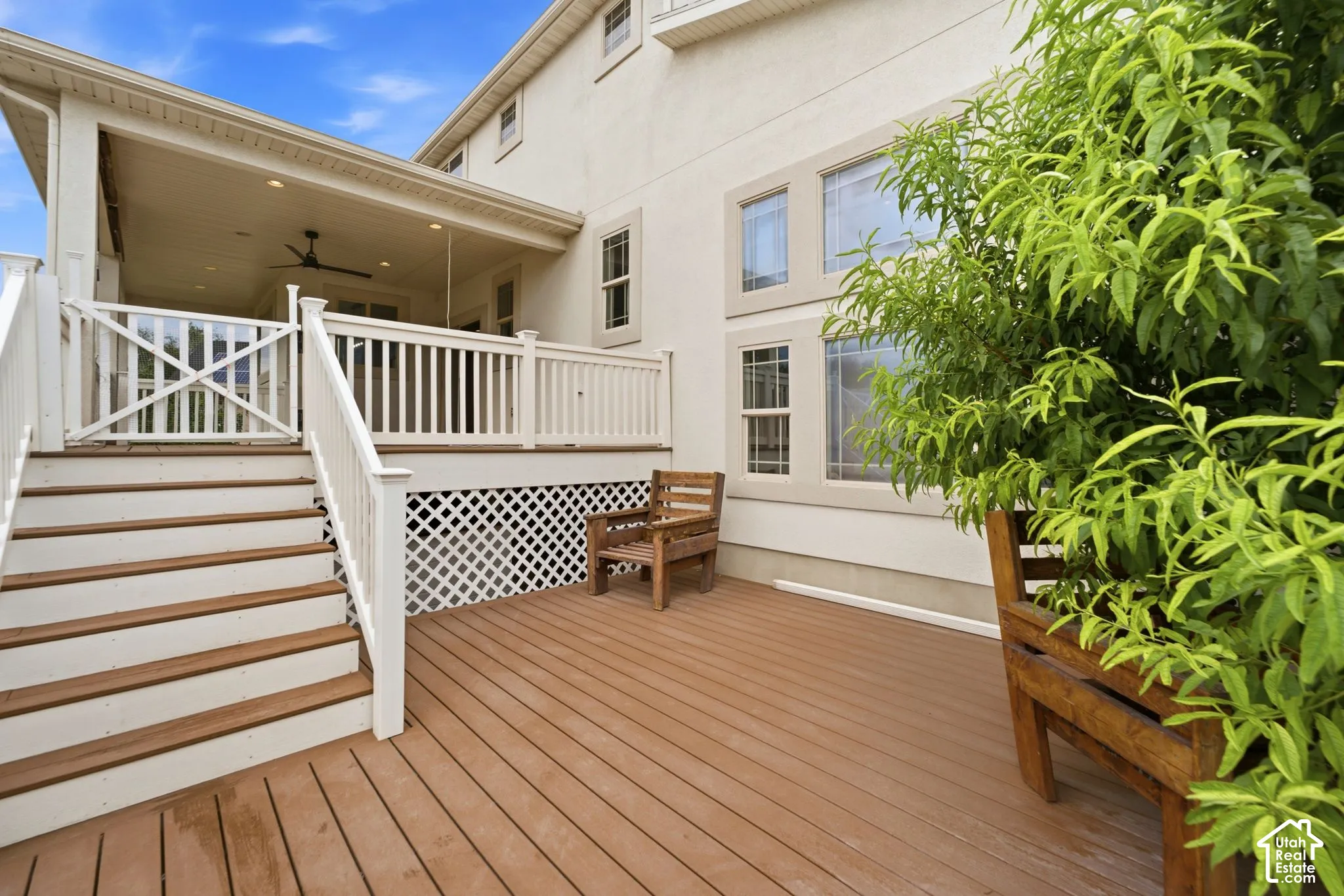 Multi-level outdoor deck space with warm-toned wood-finish flooring
