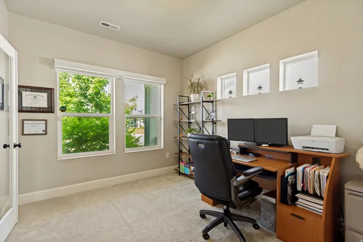 Bright room with neutral wall color and light-toned carpeting