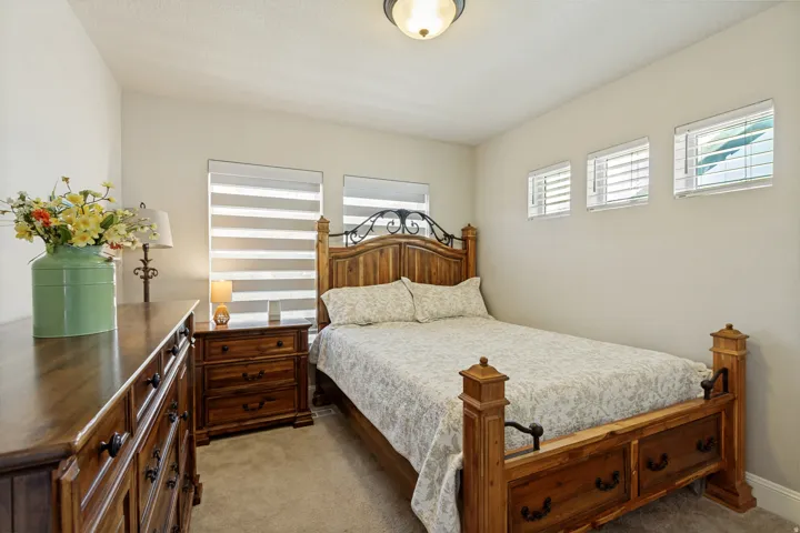 Interior room featuring light-colored walls, carpeted flooring, and a ceiling-mounted light fixture
