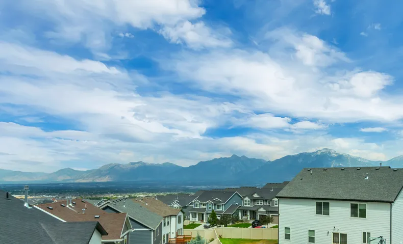 View from primary bedroom window of expansive mountain scenery with a distant cityscape