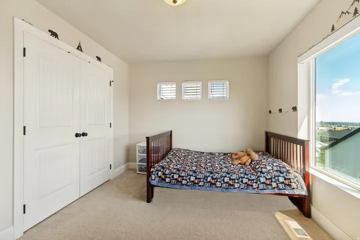 Bright room featuring a large window, three transom windows, and an overhead flush-mount light fixture