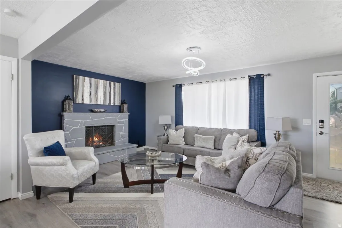 Living room featuring a stone-clad fireplace and hearth