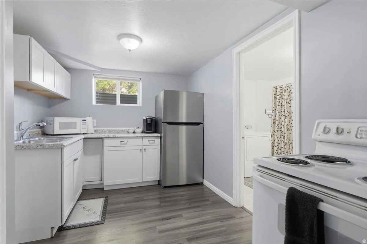 Kitchenette featuring wood-finish flooring and light gray walls