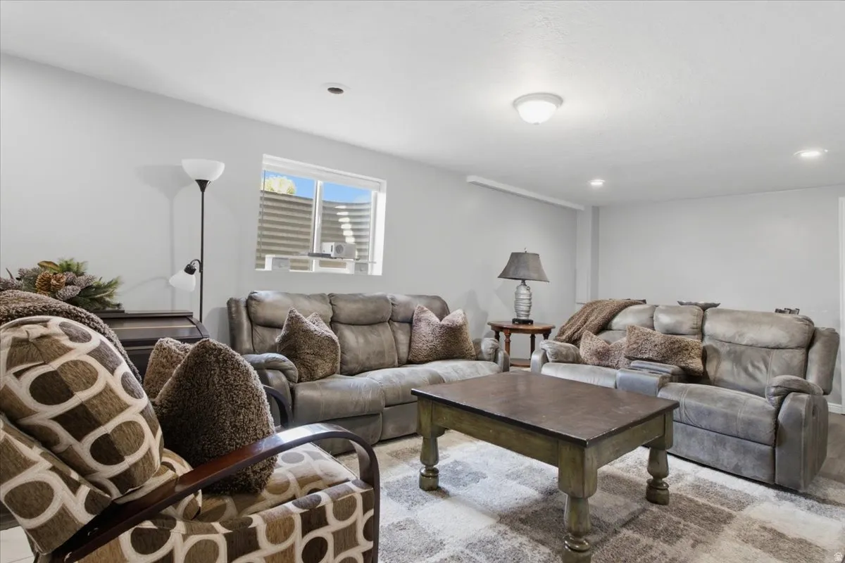 Spacious room featuring light gray walls, recessed lighting, and a window well with natural light