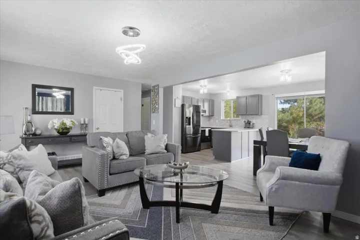 Open-concept living space featuring wood-finish flooring, recessed lighting, and light gray wall tones