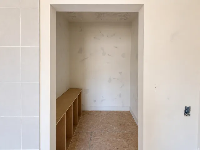 Recessed alcove featuring a built-in wood-finish cubby bench