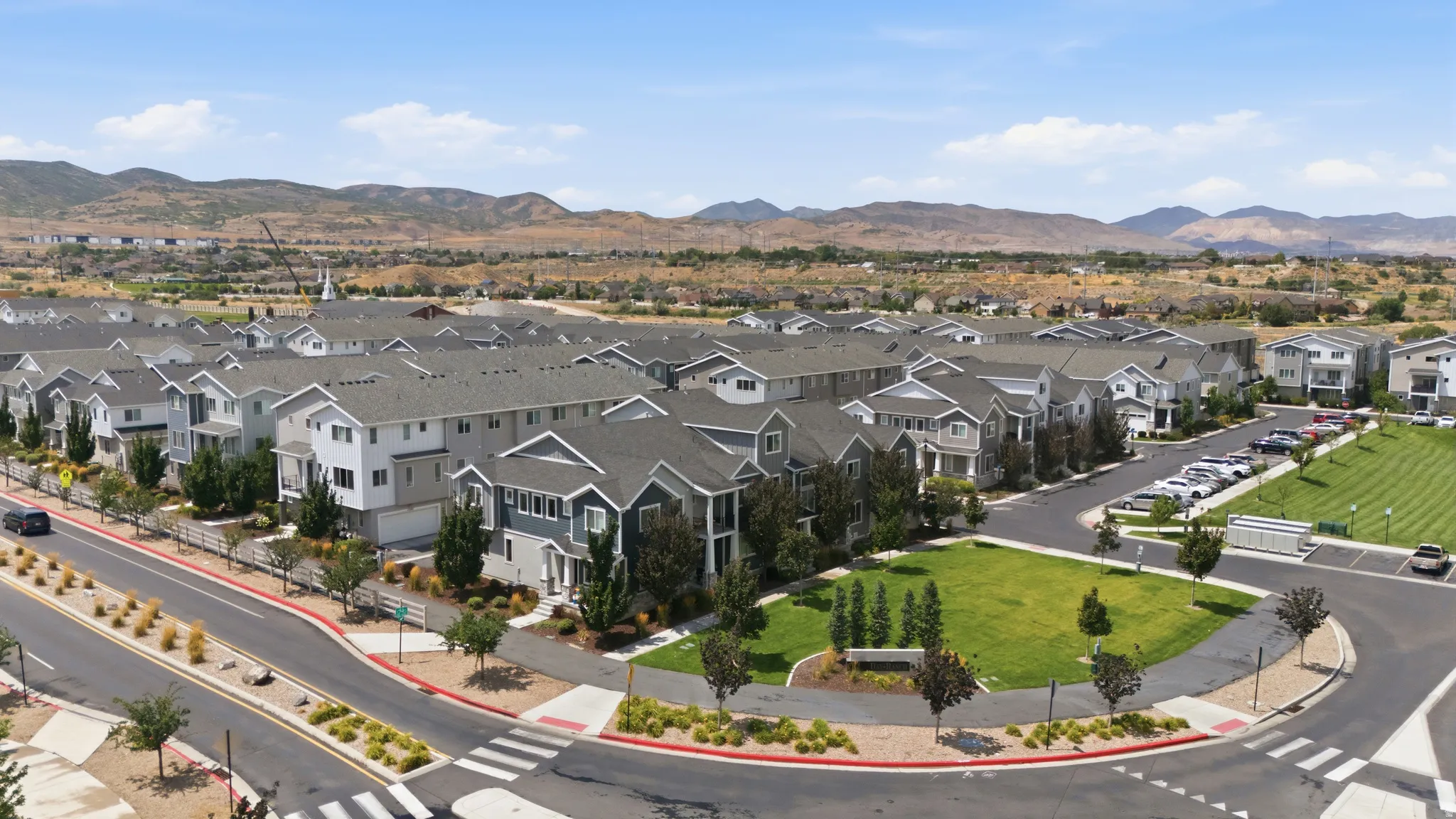 Modern residential community featuring multi-story homes with varied exterior finishes