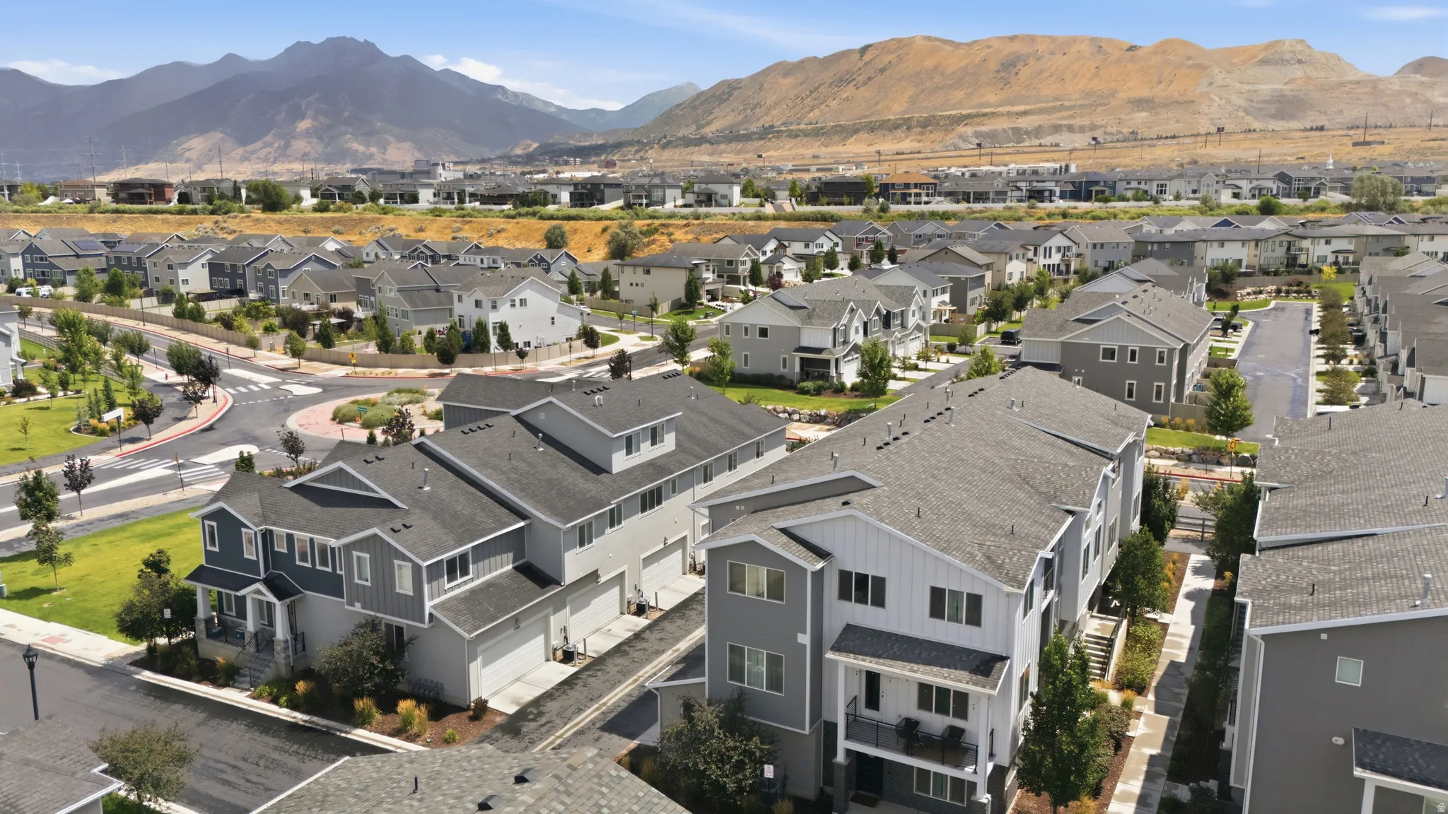 Aerial perspective showcasing a developed residential community with mountain backdrops