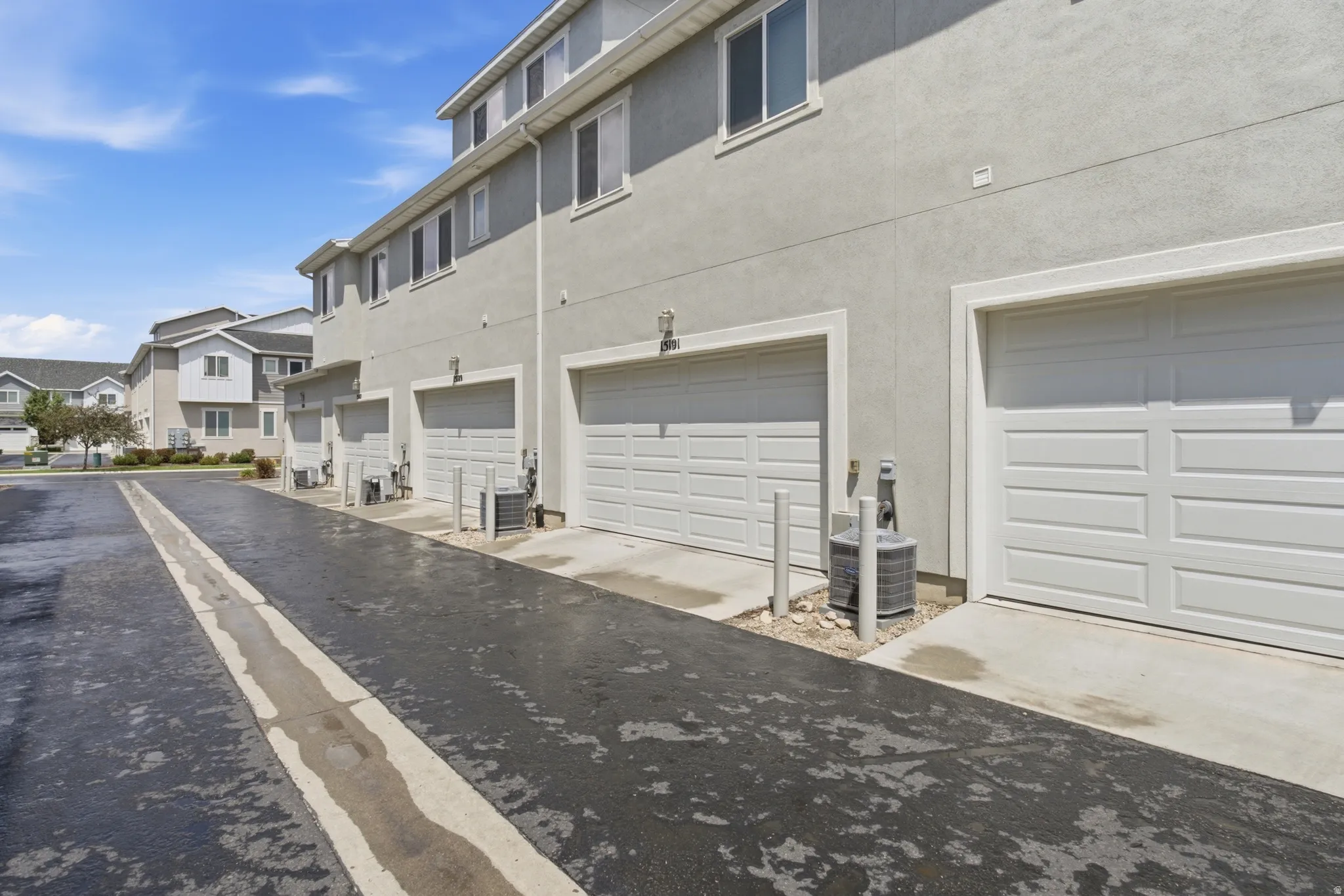 Multi-unit building exterior featuring individual garage access