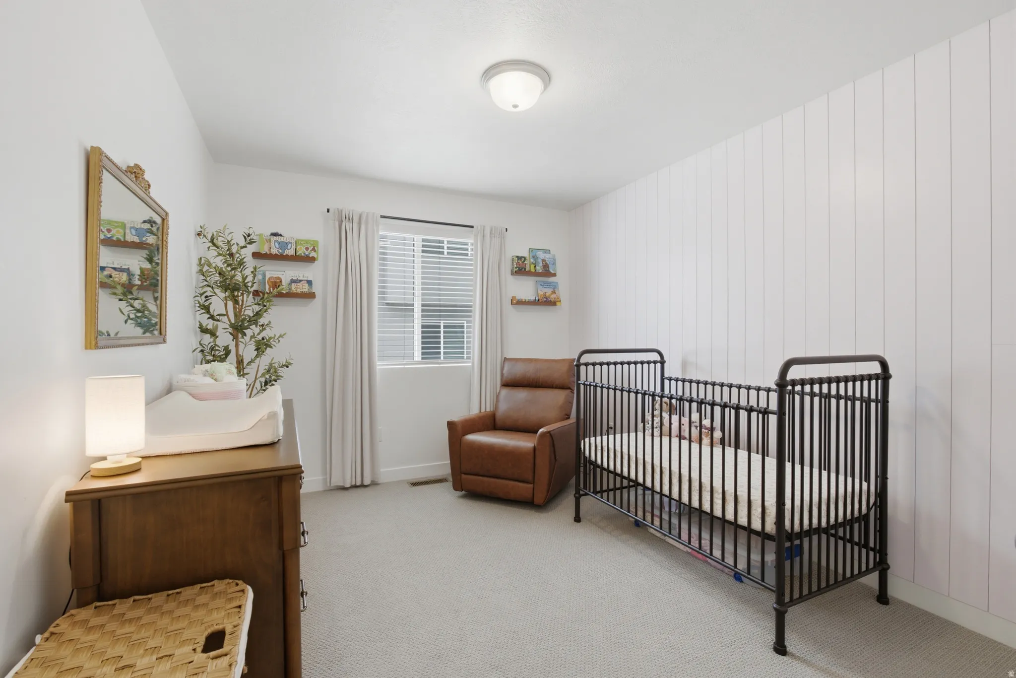 Room featuring light-colored carpeting and a window with blinds