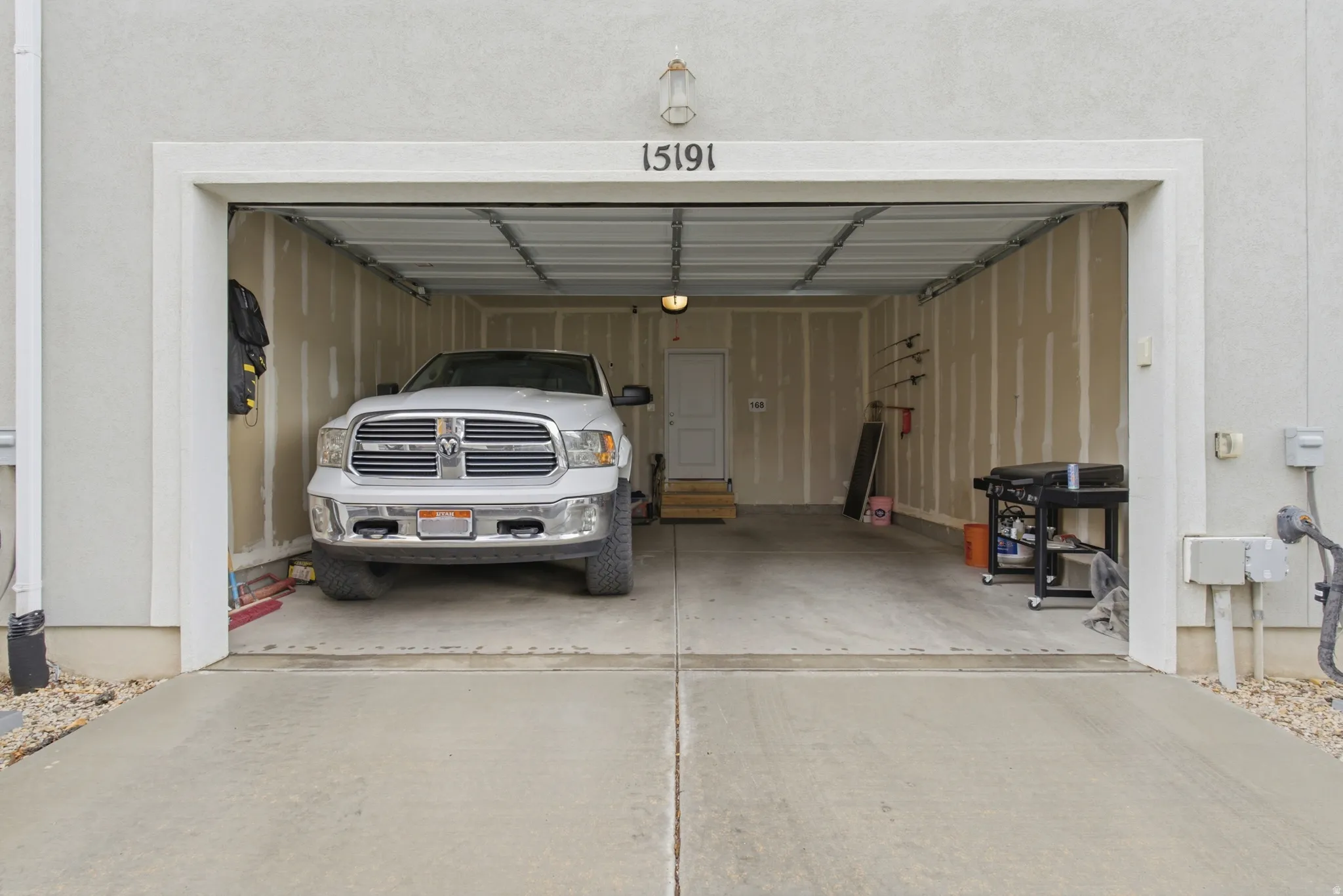 Two-car garage with concrete flooring and a white overhead door