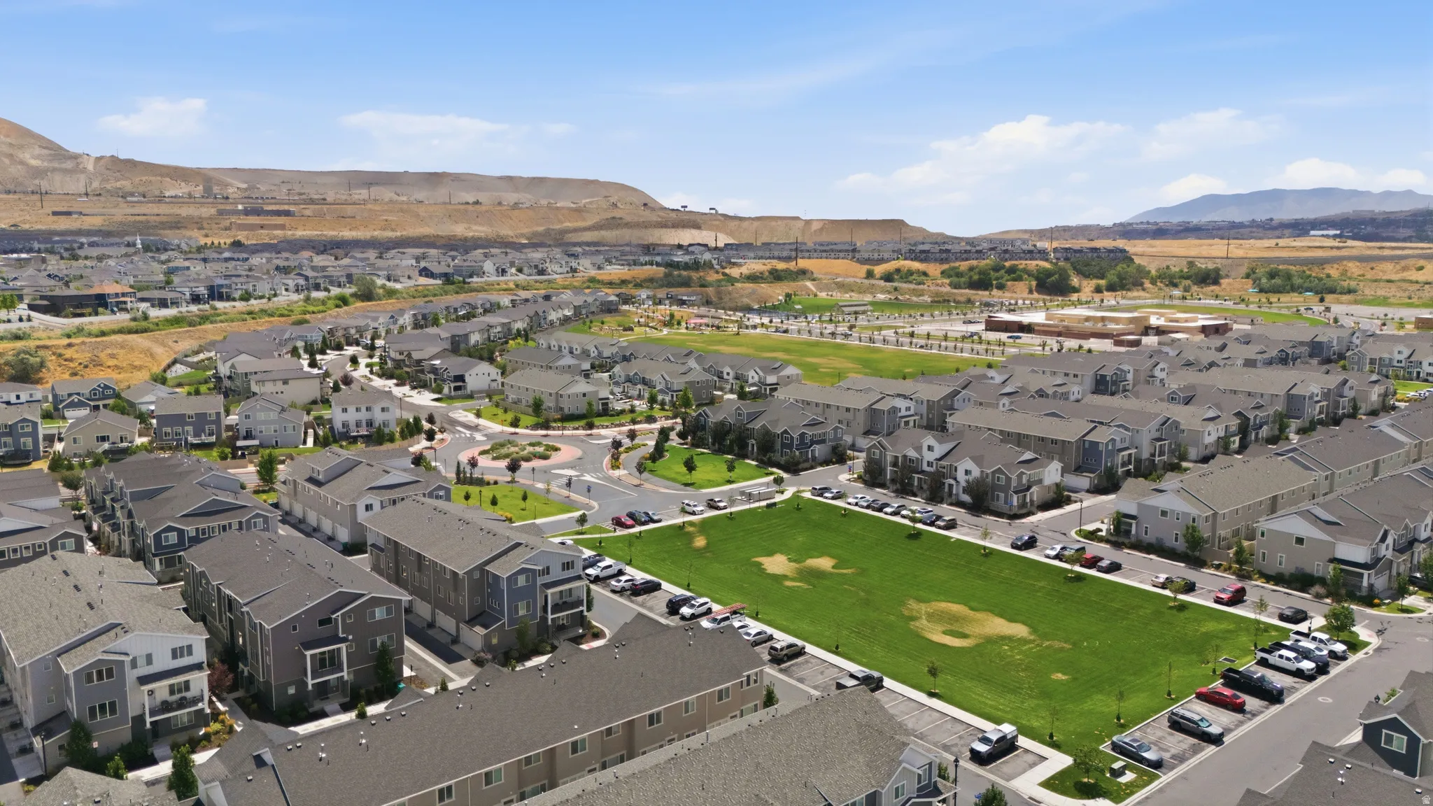 Expansive aerial view showcasing a modern residential community with varied architectural styles