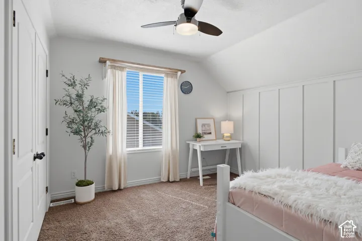Pleasantly lit bedroom with white paneled accent wall.