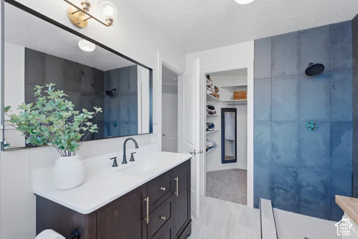 Ensuite. Bathroom vanity with a smooth, white countertop and dark contrasting cabinetry.