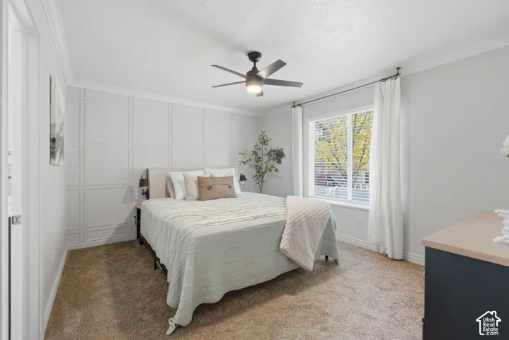 Primary bedroom with big walk in closet. The accent wall in the bedroom features custom decorative paneling.