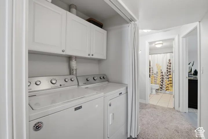 Second laundry area featuring built-in cabinetry and overhead shelving.
