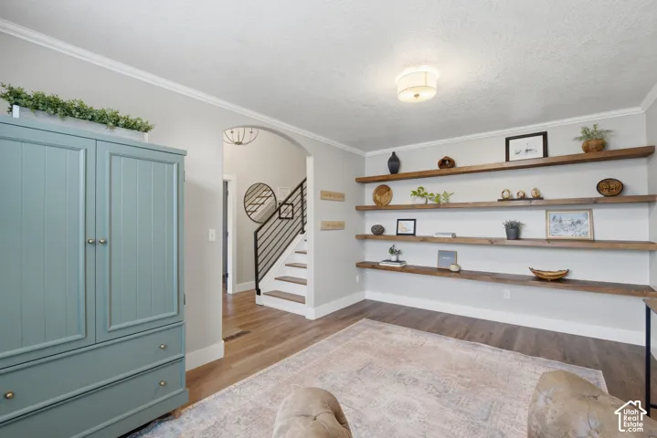 Full view of the beautiful wood shelves and the charming arched doorway that connects with the foyer.