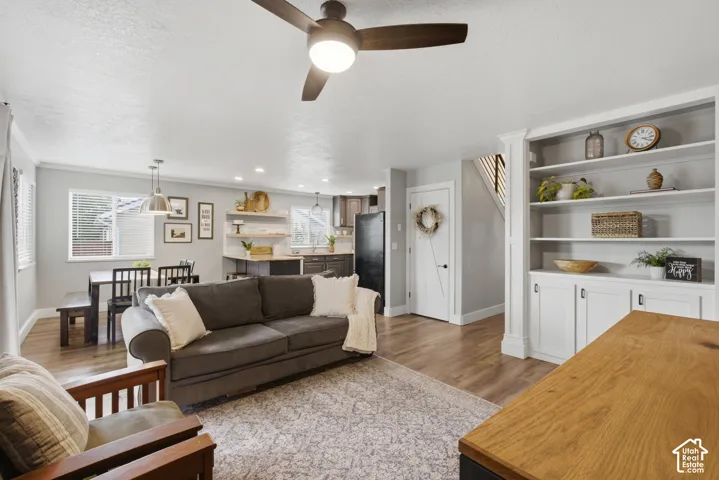 Open-concept living room features beautiful built in shelves and cabinets.