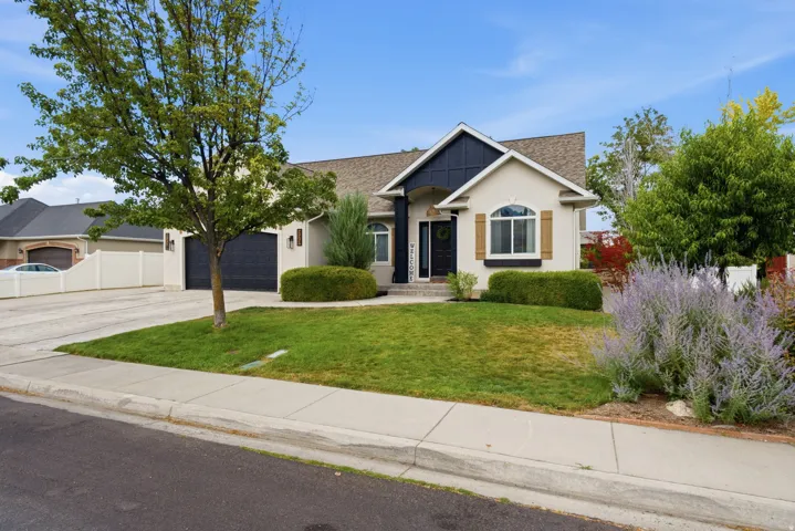 Welcome Home! Stucco exterior with beautiful trim accents and a prominent arched garage door.