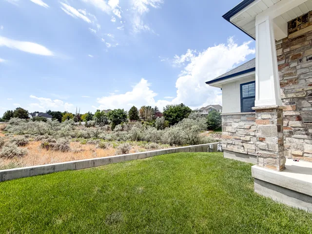 Exterior featuring a stone veneer facade and white columns