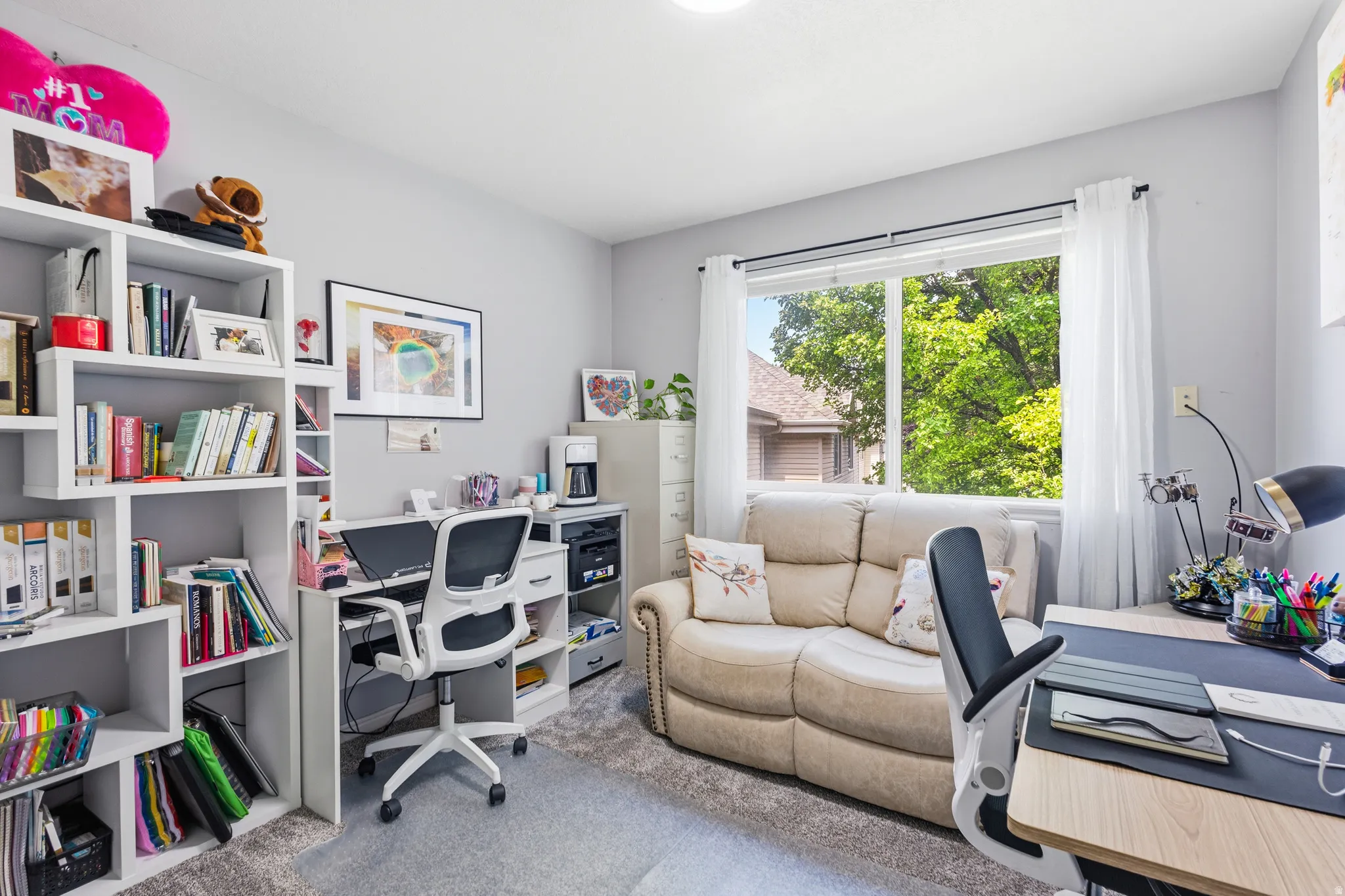 Dedicated room featuring a large window, light gray wall paint, and gray carpet flooring