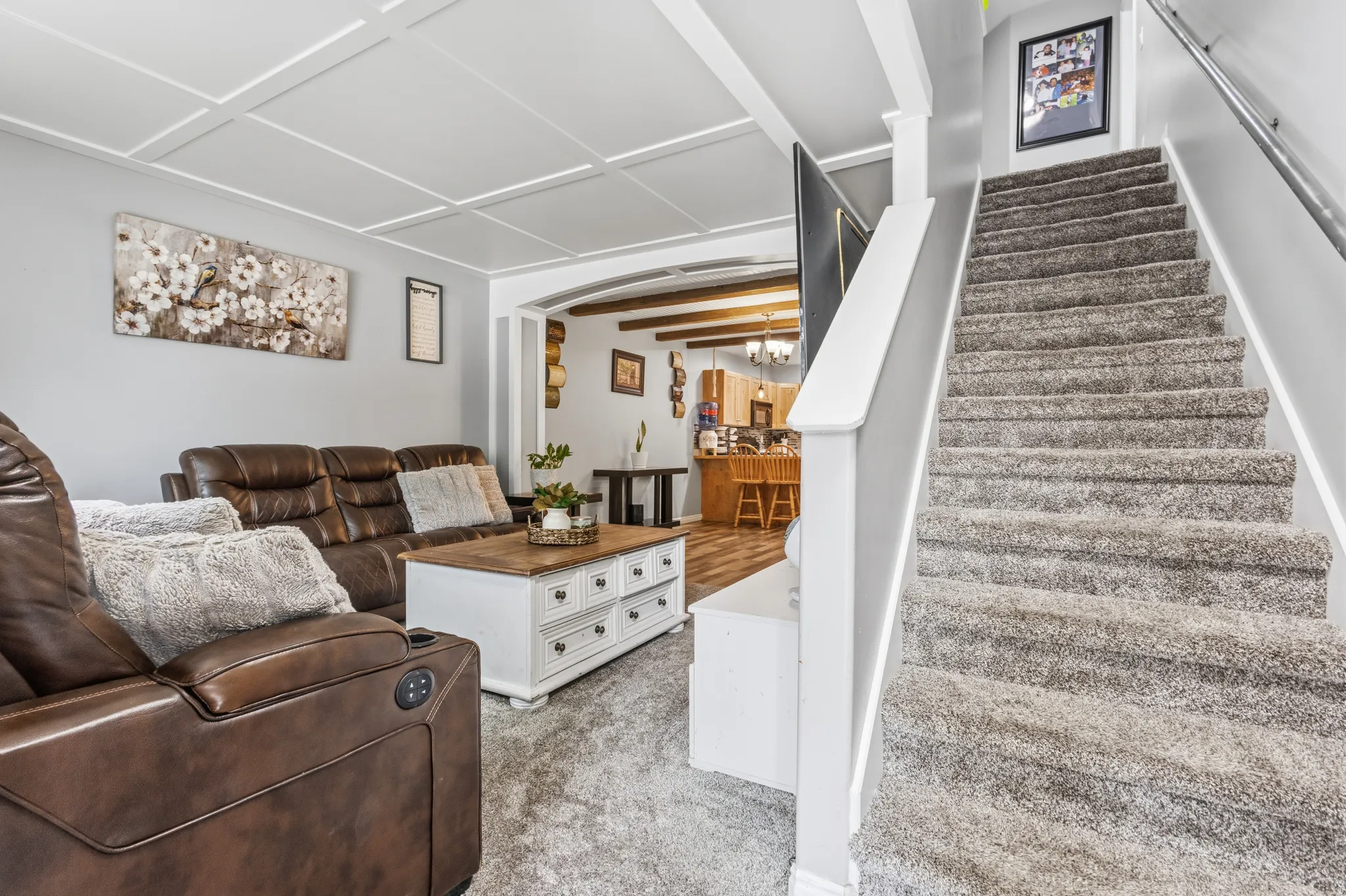 Carpeted staircase with white balusters