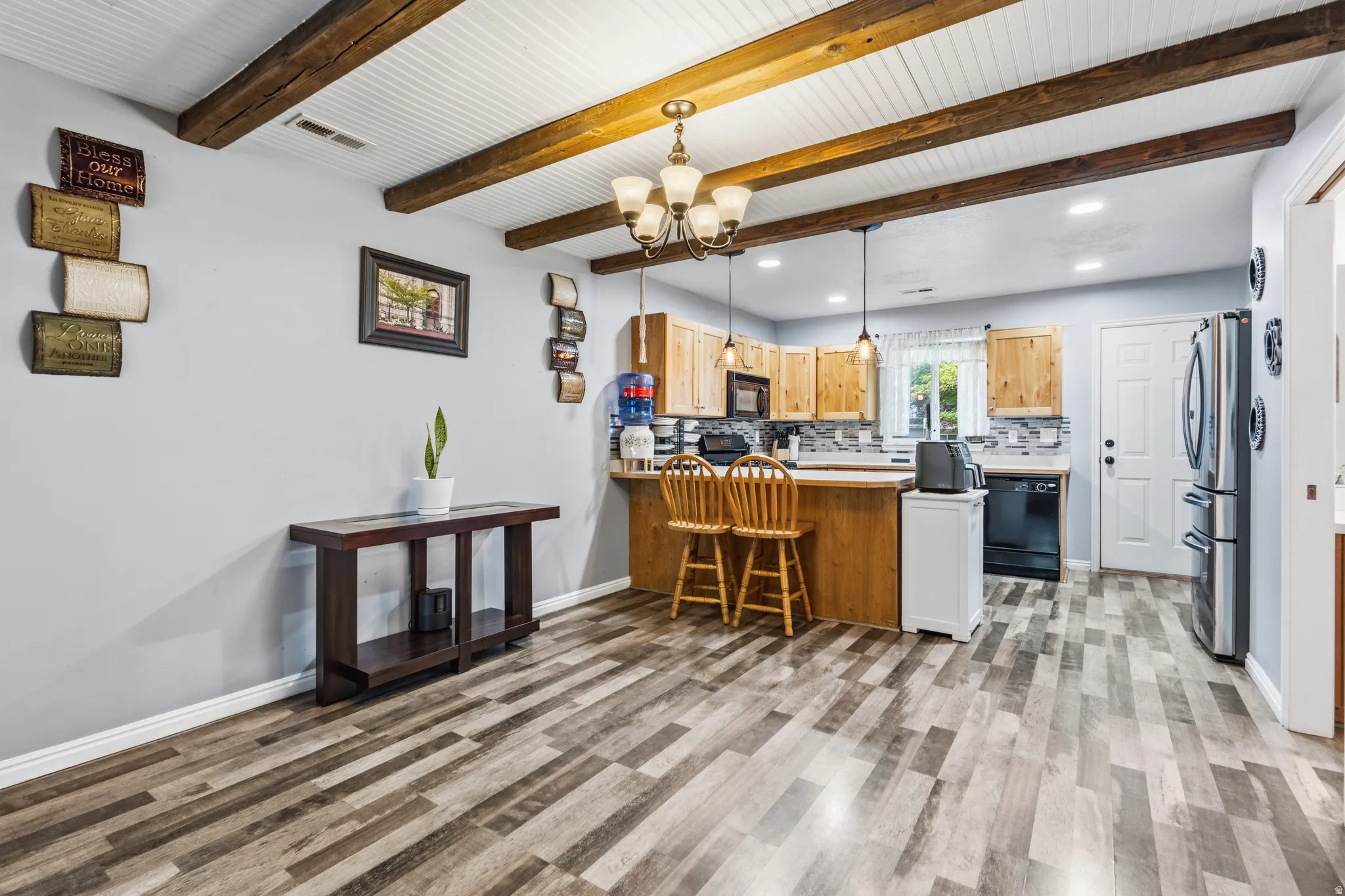 Open-concept kitchen and dining area with wood-finish flooring
