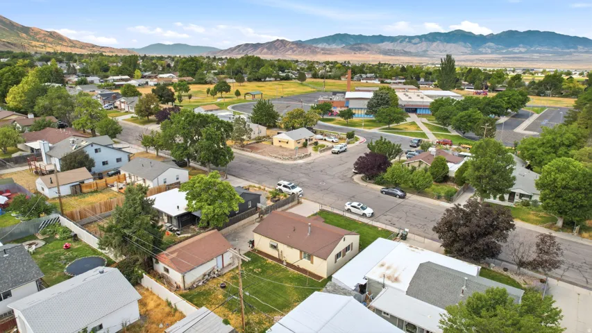 Aerial perspective showcasing residential properties with surrounding mountain ranges