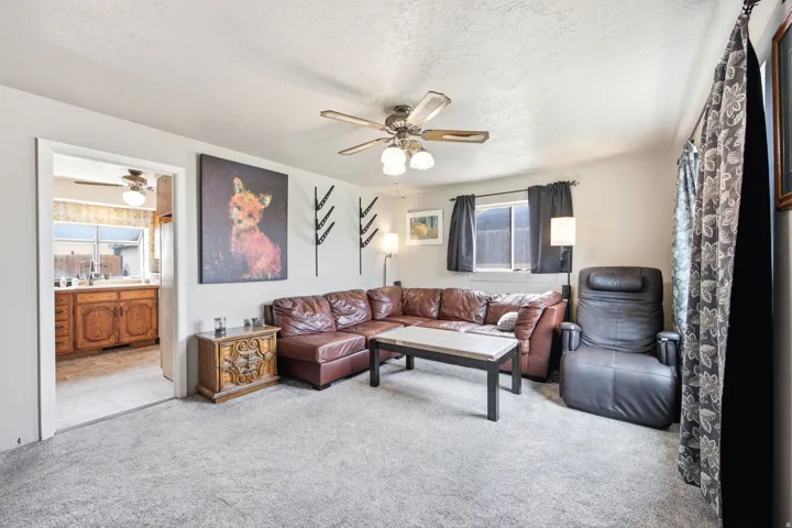 Living area featuring neutral-toned walls and carpet flooring