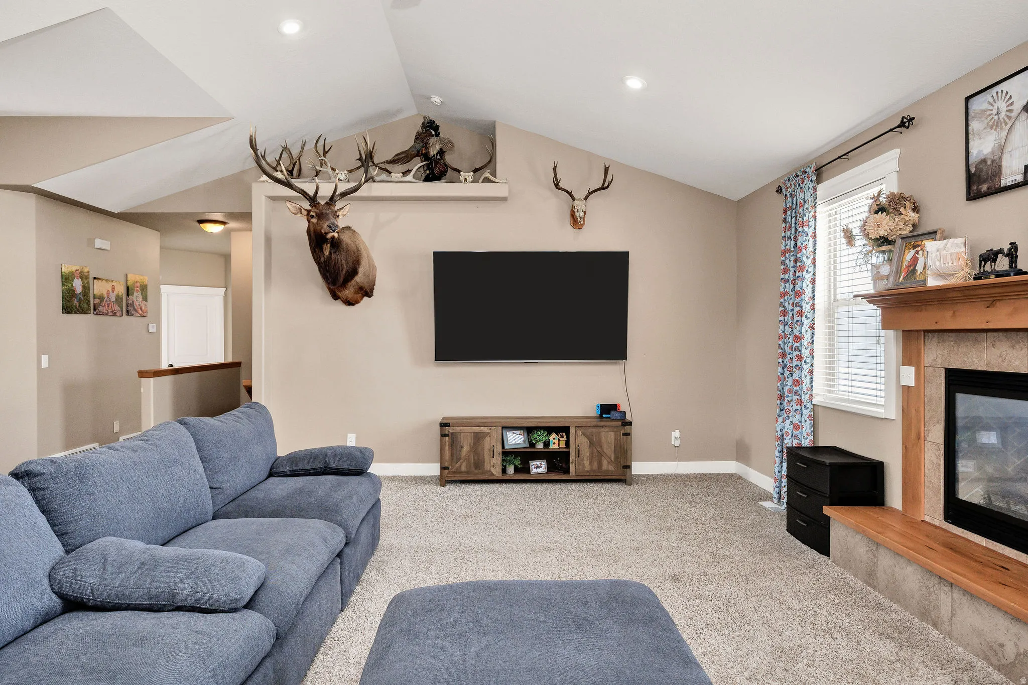 Spacious living area featuring vaulted ceilings, recessed lighting, and neutral wall tones