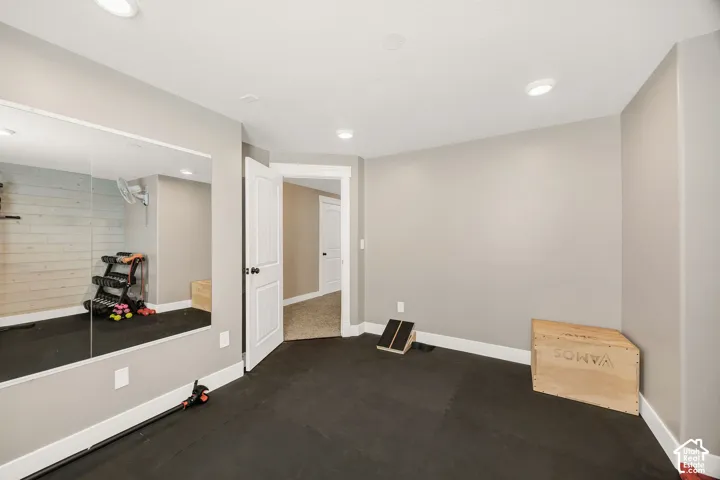 Dedicated space featuring rubber flooring and a full-wall mirror