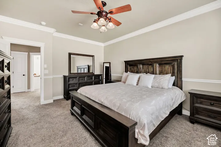 Spacious room featuring neutral wall tones, crown molding, and a ceiling fan with integrated lighting