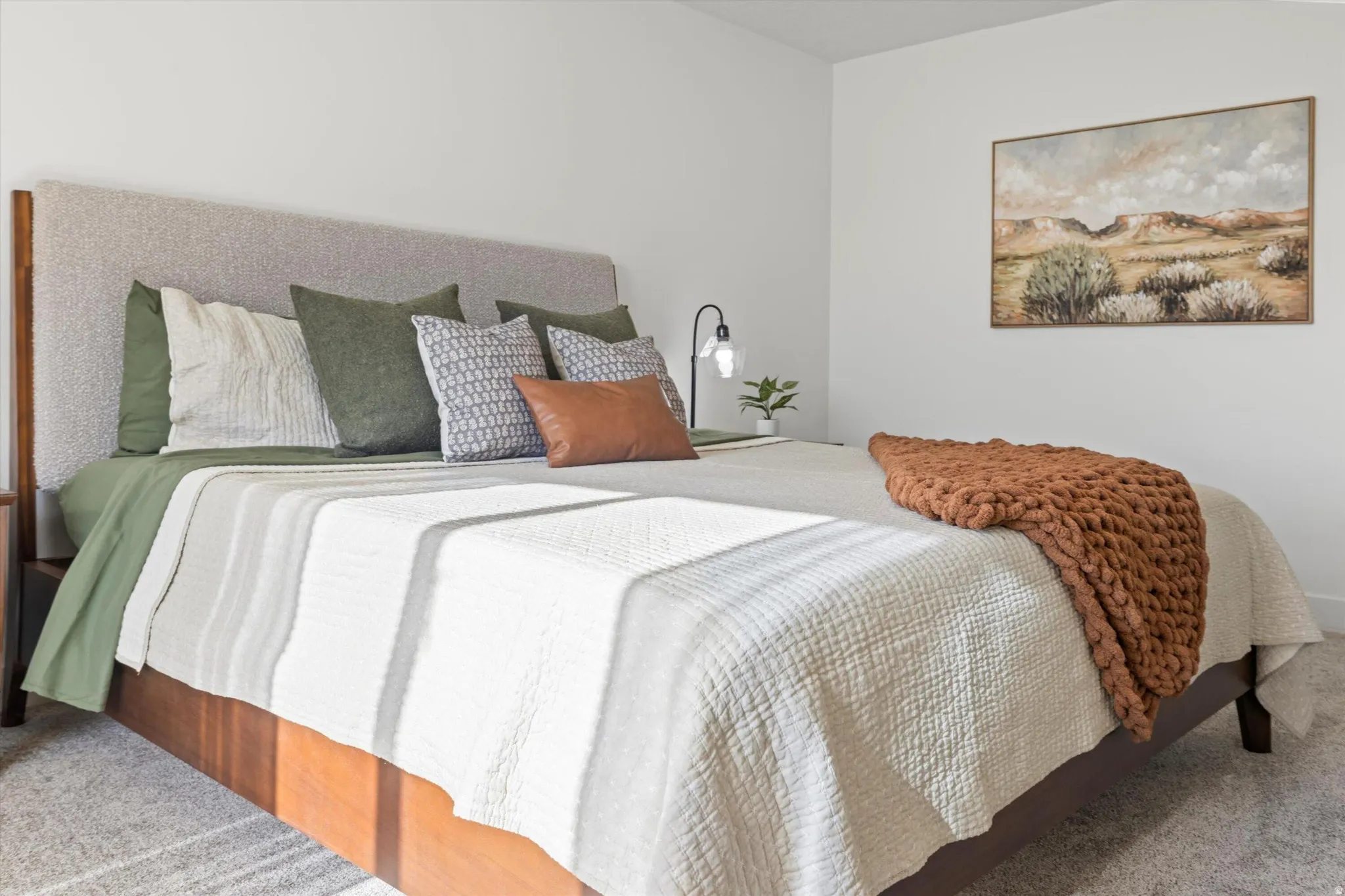 Bedroom featuring a neutral color palette, light gray carpeting, and white walls