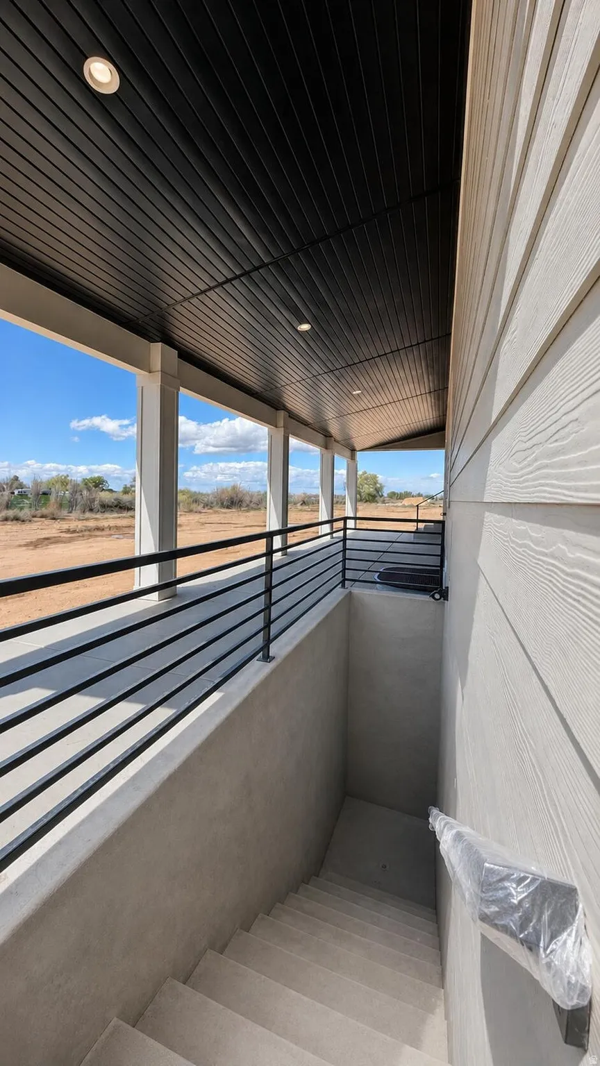 Covered porch featuring a black slatted ceiling with recessed lighting