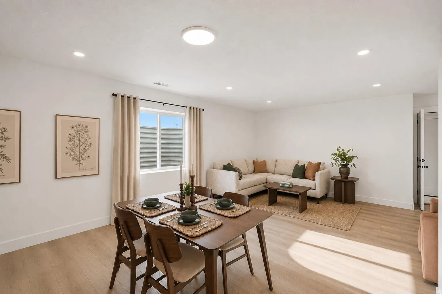 Open-concept living area featuring light wood-finish flooring throughout
