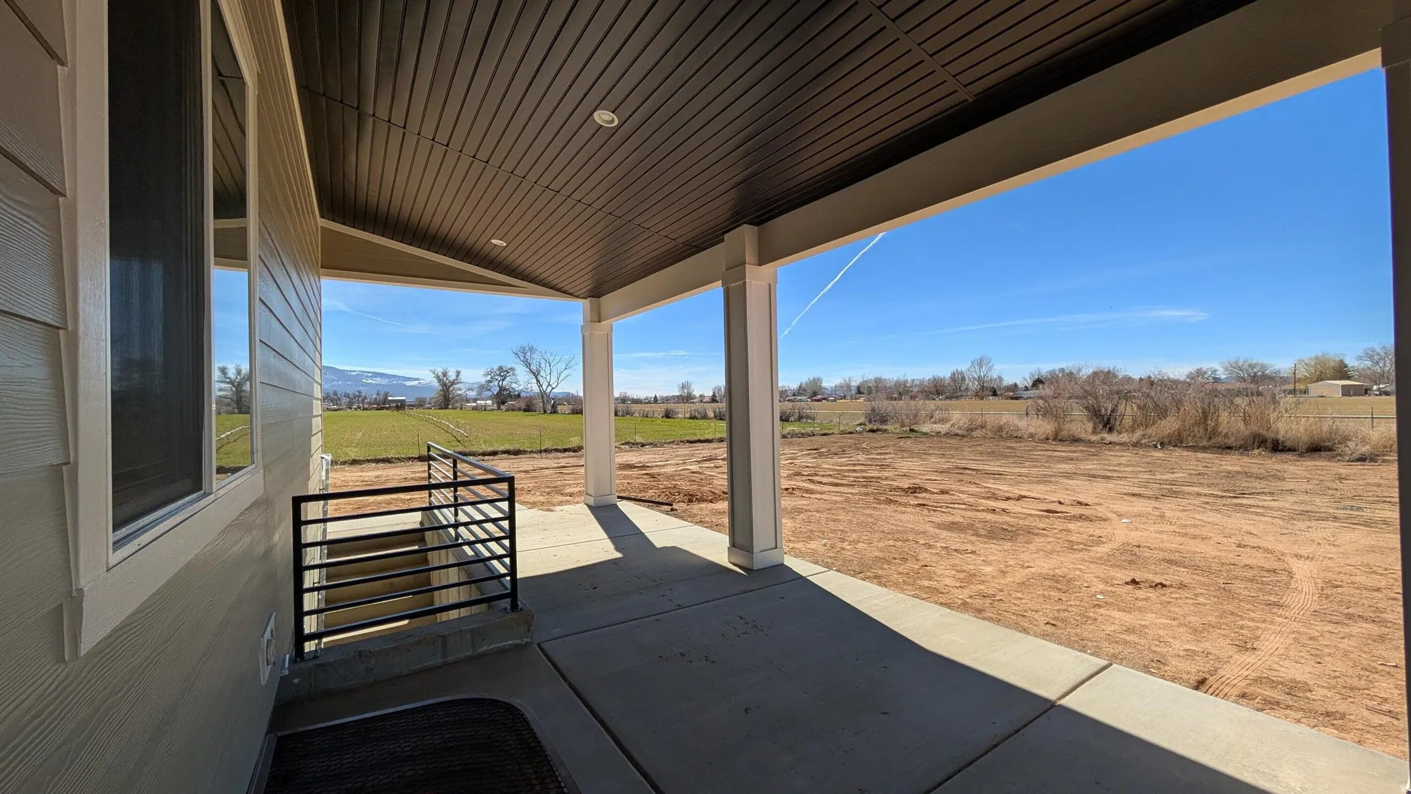 Covered front porch featuring recessed lighting, a concrete slab, and painted support columns