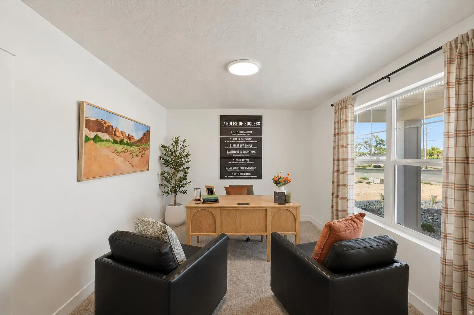 Inviting interior room featuring a large window, recessed lighting, and neutral carpet flooring