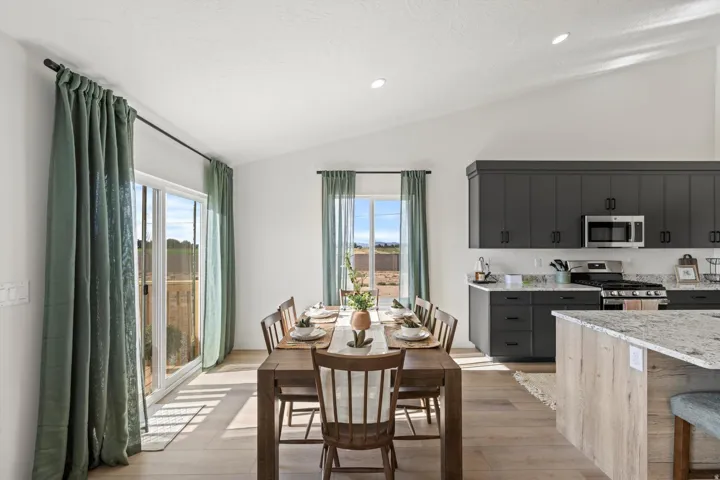 Vaulted ceilings highlight this open-concept dining area and kitchen