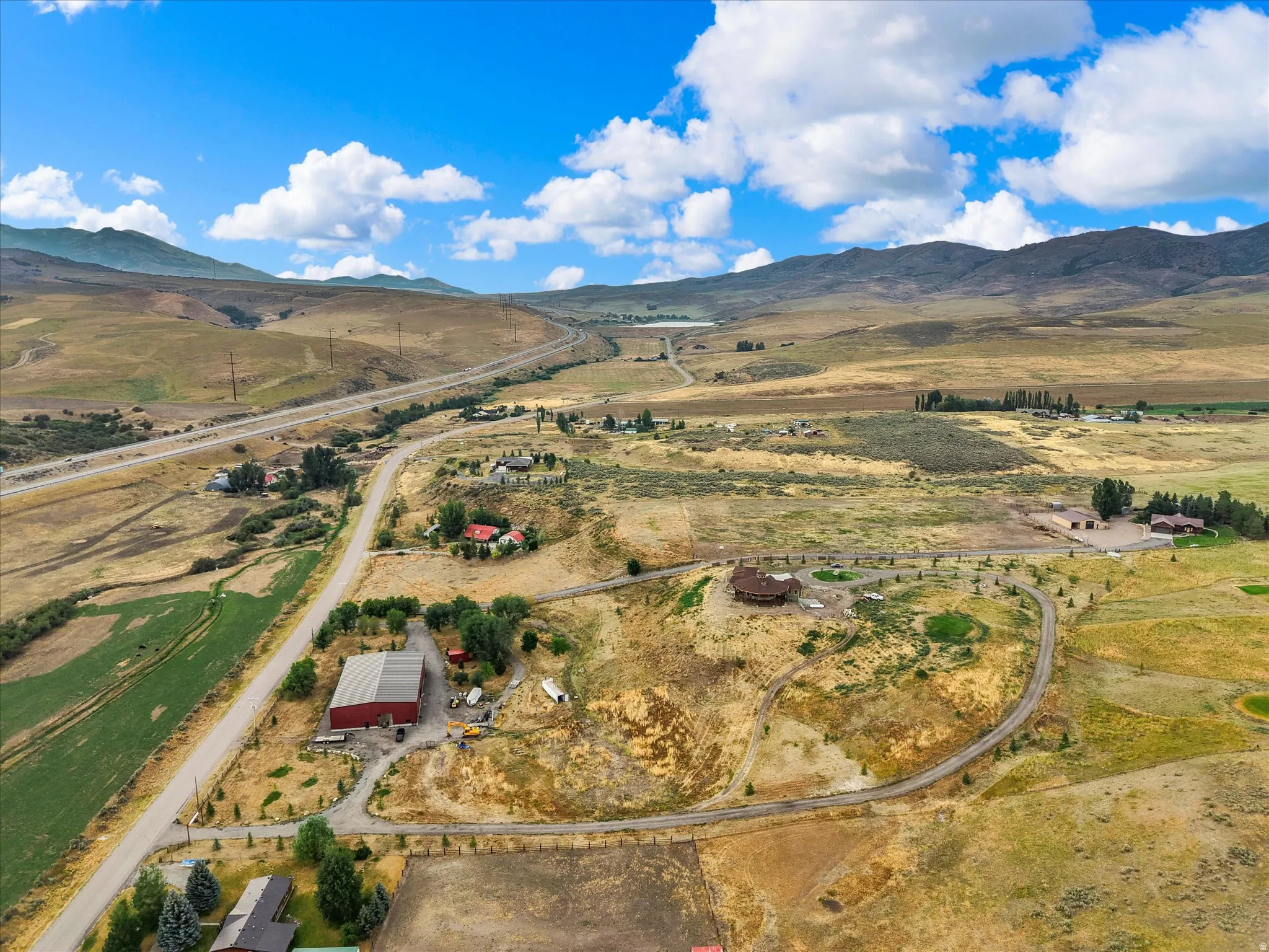 Expansive aerial perspective showcasing a rural landscape with distant mountains
