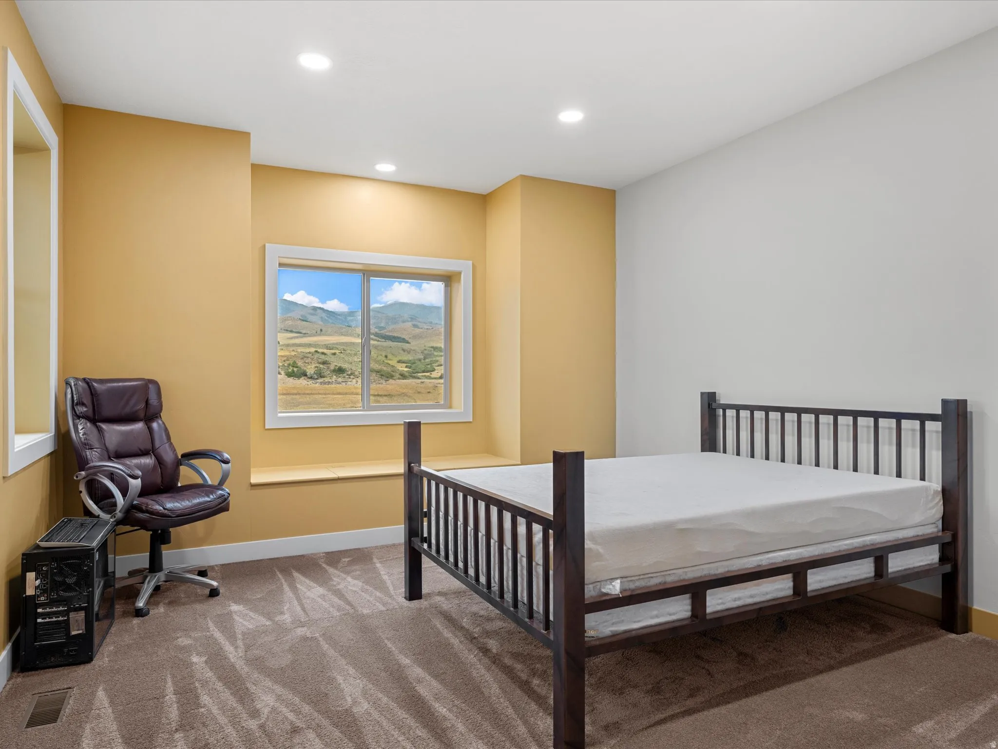 Window-framed mountain scenery with a built-in window seat