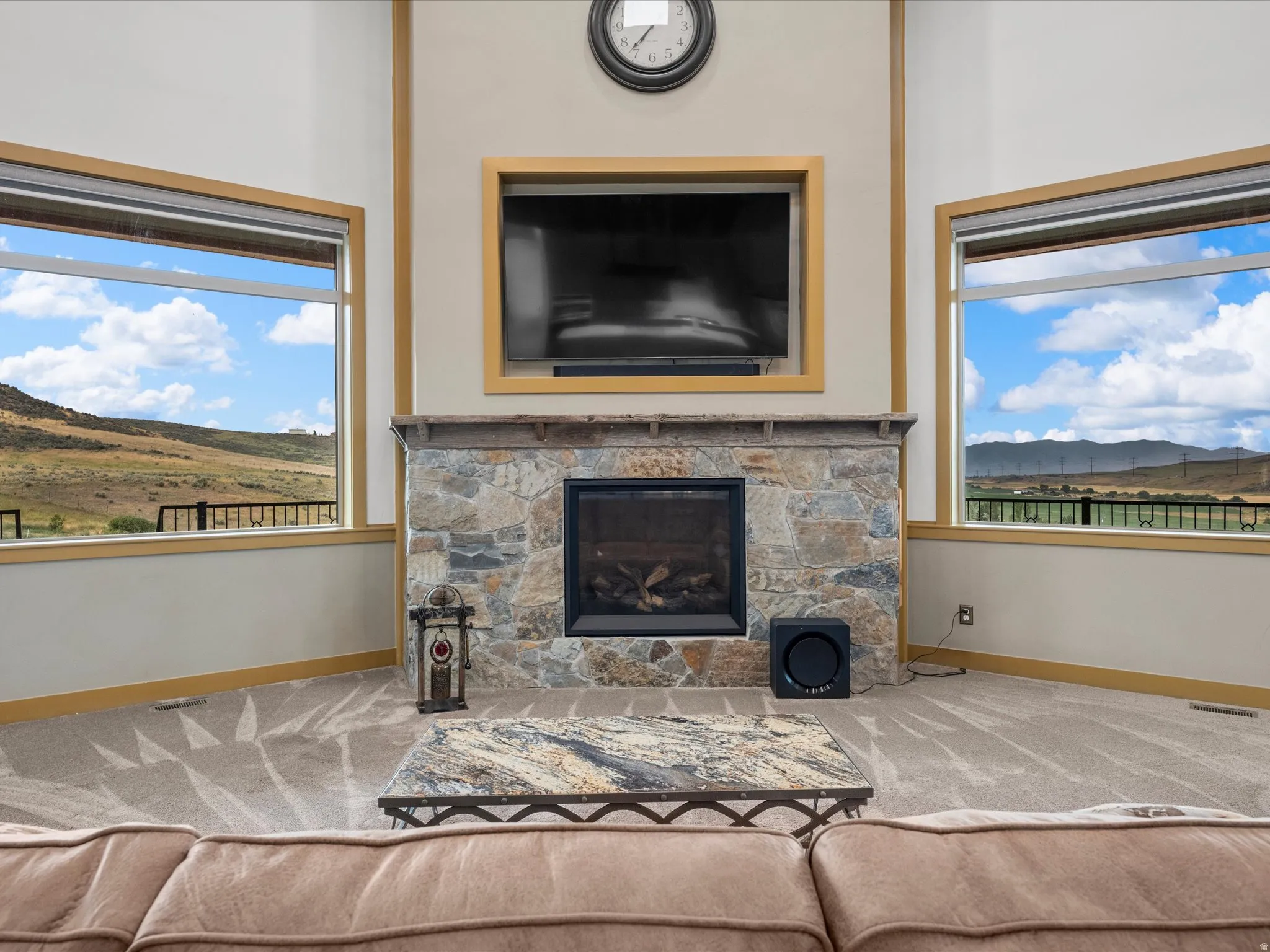 Stone-faced fireplace with a dark metal firebox and mantel