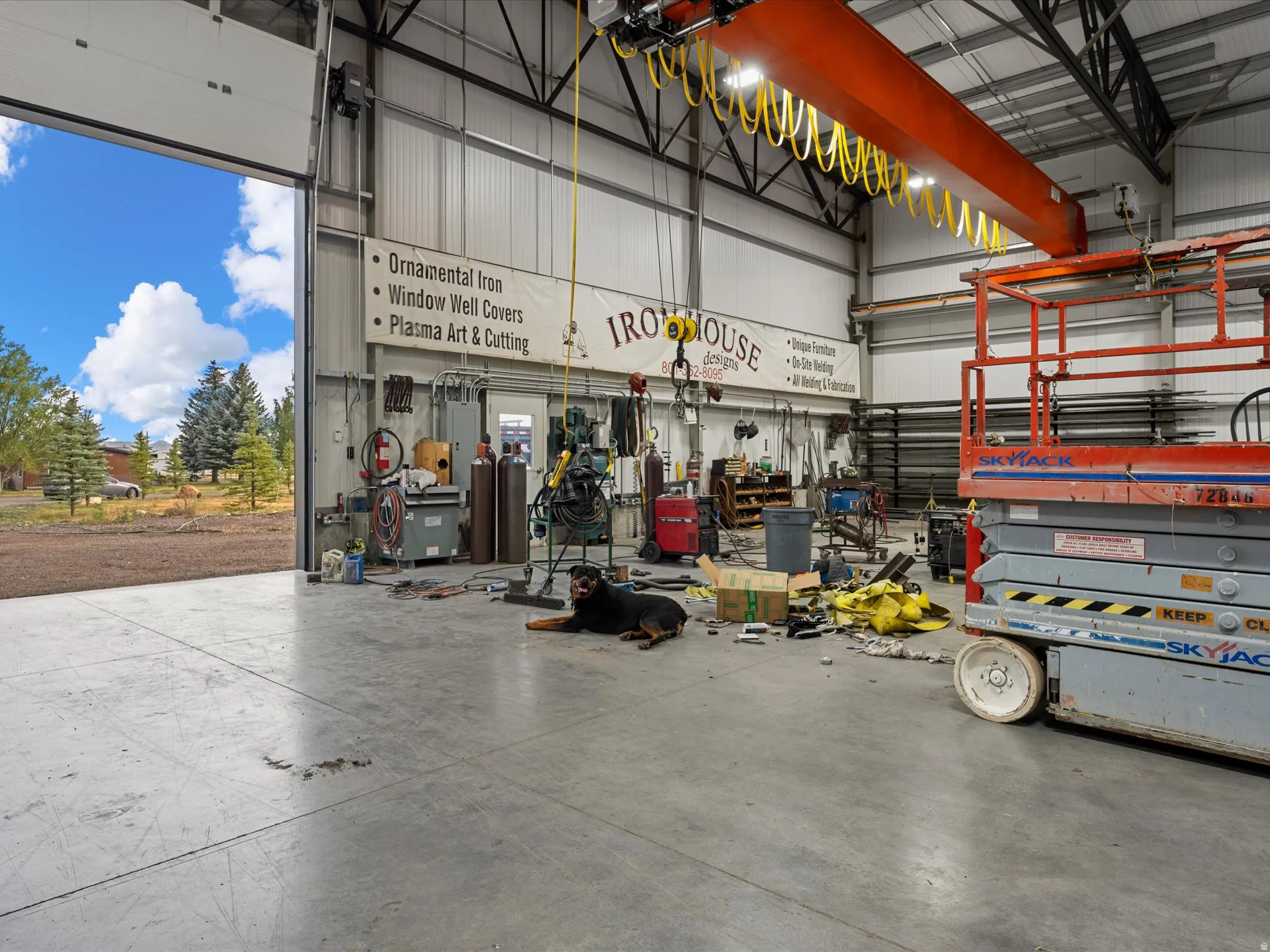 Industrial-style interior featuring high ceilings, exposed structural beams, and a large overhead crane system
