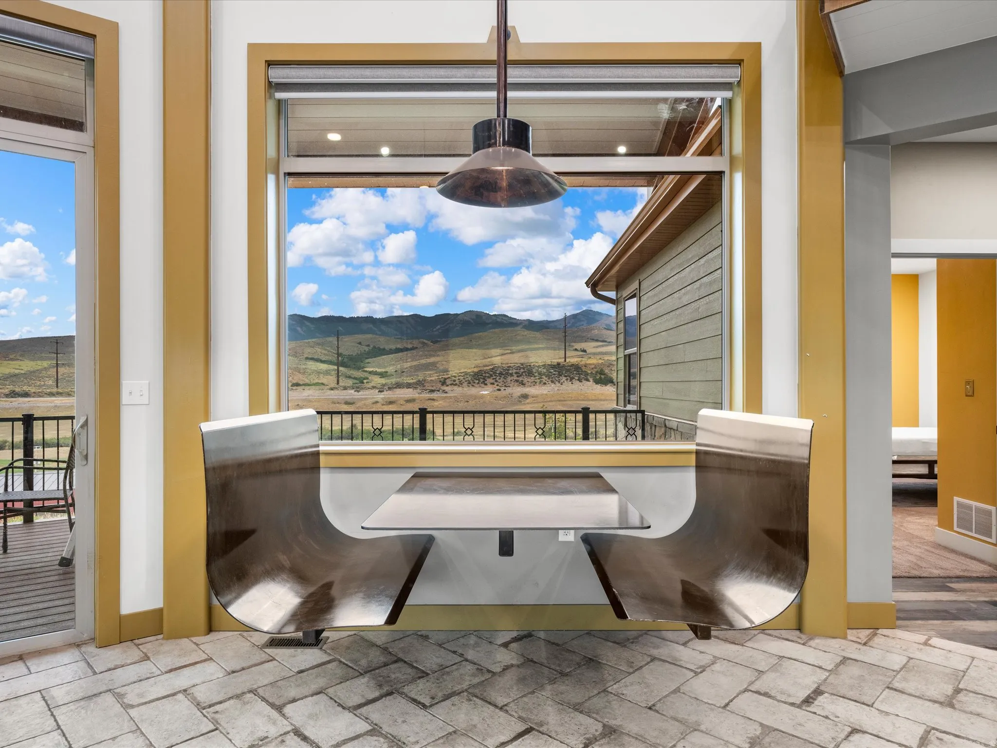 Built-in dining nook featuring a full-frame window, integrated seating, and a pendant light fixture