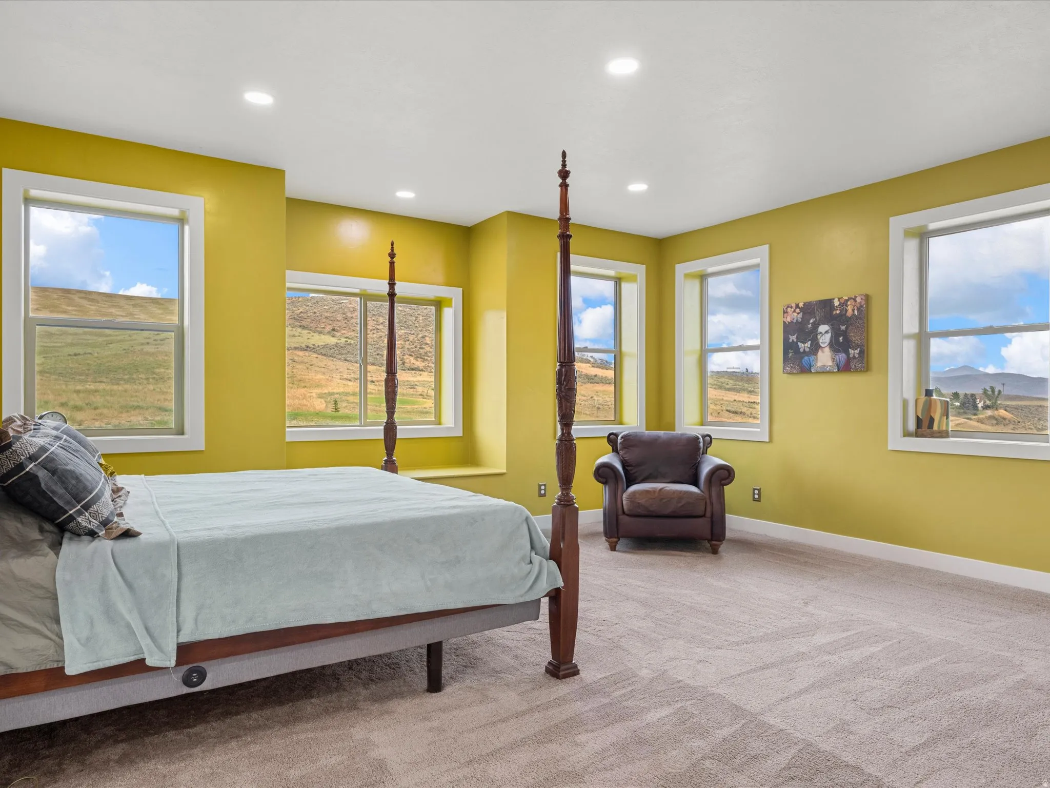 Spacious room featuring multiple windows, recessed ceiling lighting, and carpet flooring