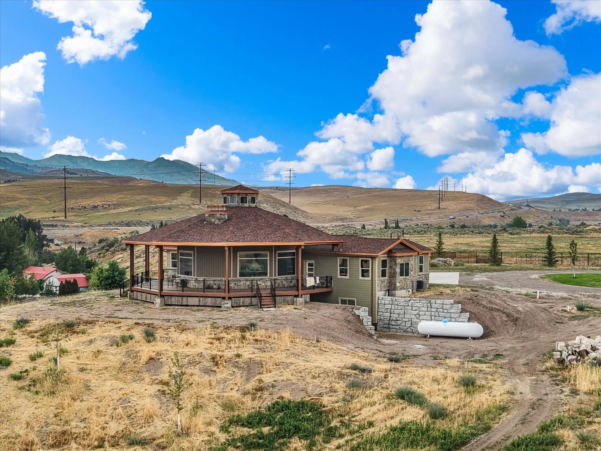 Expansive property featuring a multi-level residence with a large wrap-around deck
