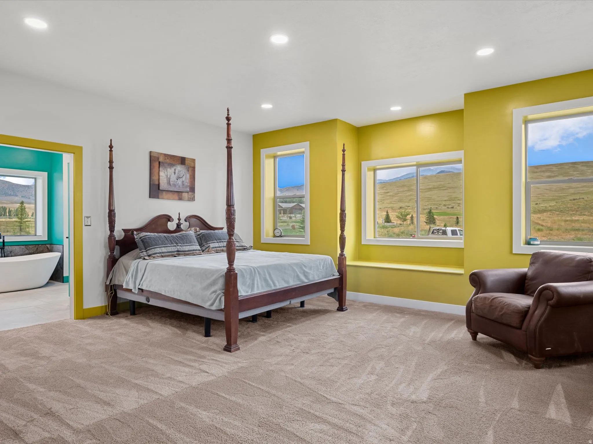 Spacious room featuring broadloom carpet, recessed lighting, and yellow accent walls