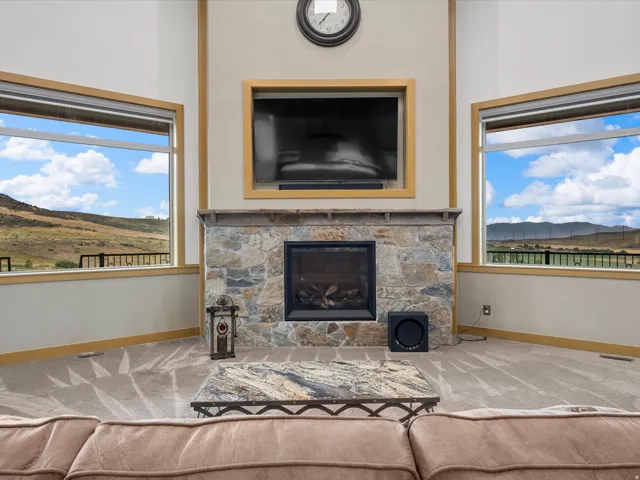 Stone-faced fireplace with a dark metal firebox and mantel