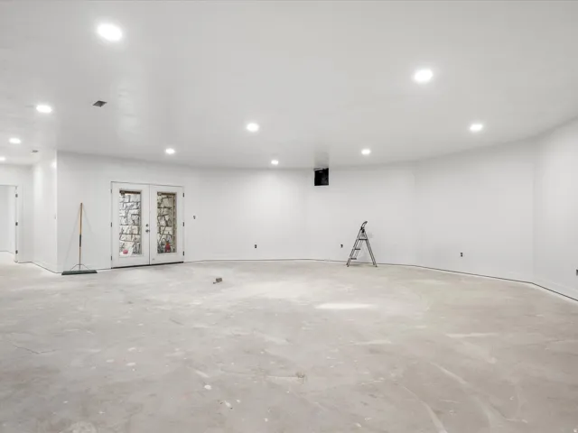 Spacious unfinished room with recessed lighting and concrete flooring