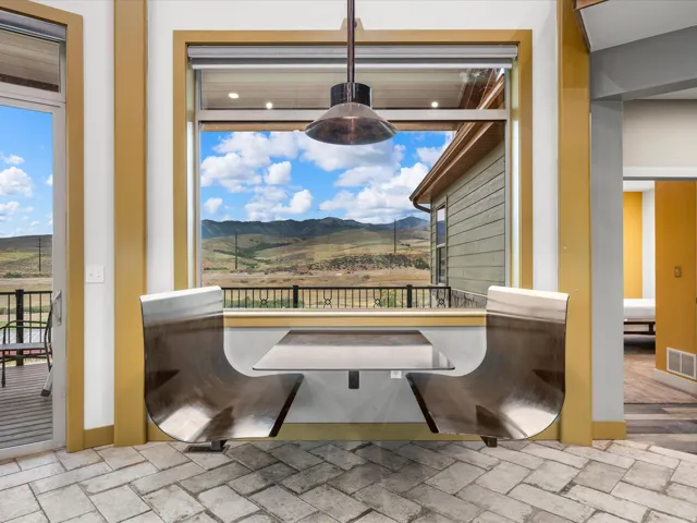 Built-in dining nook featuring a full-frame window, integrated seating, and a pendant light fixture